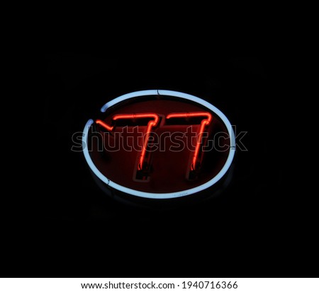 Vintage Neon 77 Sign in Restaurant Window
