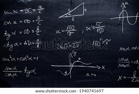 Blackboard inscribed with scientific formulas and calculations in mathematics. Science and education background.