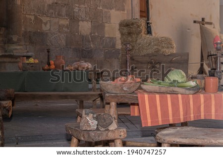 Medieval tavern with tables, benches and utensils of the time