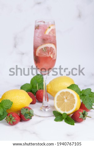 Lemon and strawberry lemonade mint fresh homemade in glass, Summer cold cocktail, Strawberry lemon lime mojito, light background, copy space, A refreshing summer drink concept.