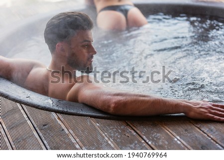 couple bathe in vats outdoors