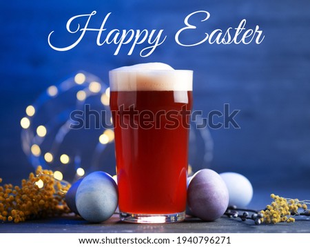 A glass of limited-edition craft beer and colored eggs. Happy Easter Greetings
