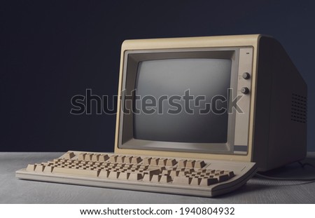 Vintage personal computer with keyboard on a desktop, outdated electronics concept Royalty-Free Stock Photo #1940804932