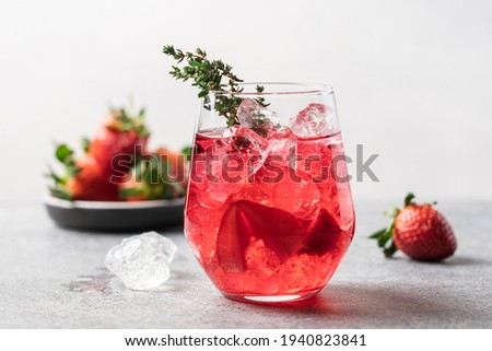 Berry drink with crushed ice and thyme. Strawberry and blueberry lemonade. Summer refreshing drink Royalty-Free Stock Photo #1940823841