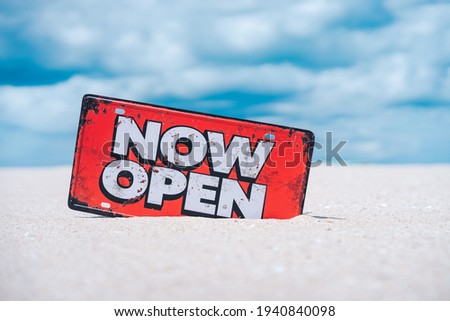 Open sign on tropical sand beach with blue sky background. Summer vacation and travel holiday concept. Vintage tone fitler effect color style.