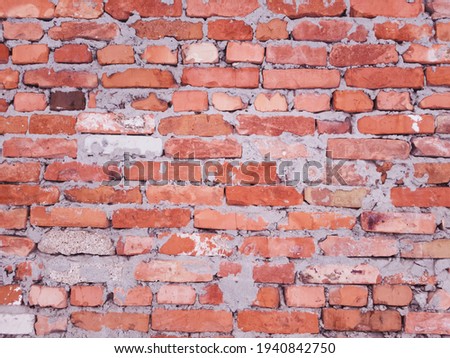Red brick wall with very low quality masonry. The work of a bad master.
