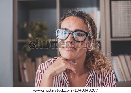 Portrait of one young and happy cheerful woman smiling looking at the camera having fun. Headshot of female person working at home in the office.