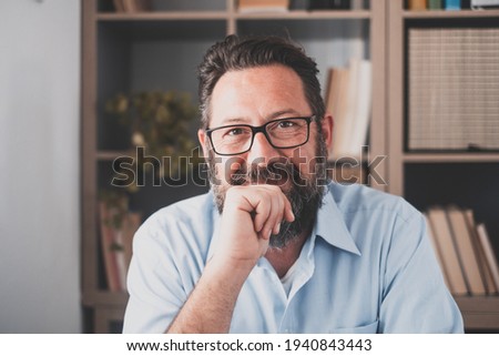 Portrait of one happy cheerful artist man looking at the camera taking inspiration to draw or paint at home. Businessman in the office working and smiling