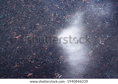 black tile with brown spots and created a spot of white spray paint