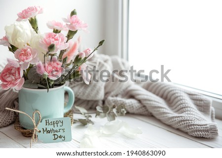 Spring still life with flowers in a vase and the inscription Happy Mother's Day on the postcard.