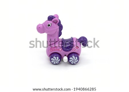 Purple plastic toy horse isolated on white