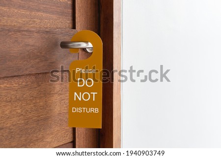 Door of hotel room with sign please do not disturb. Close up