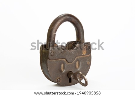 Vintage style copper lock and key isolated on white background. Antique objects. Horizontal close-up.  Royalty-Free Stock Photo #1940905858