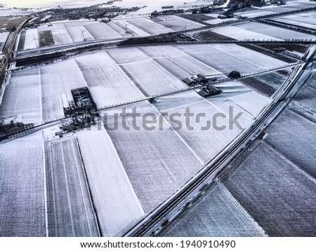 Rural landscape, Farmfield covered in snow, The Netherlands from above.
