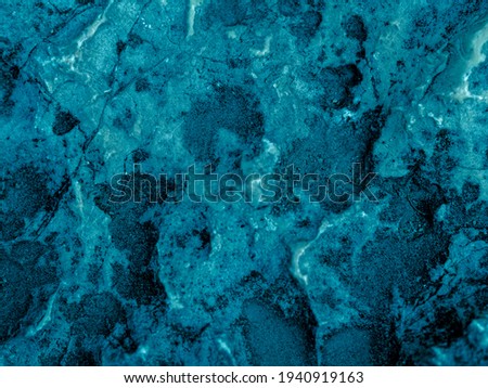 Rough textured light turquoise cosmic blue matte abstract stone with cracks and relief background. Wall. Top view