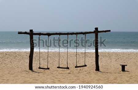 
Padubidri,Karnataka,India-February 25 2021; A Panoramic Twilight picture of deserted Wooden Swings on the Sands of Padubidri beach during the Covid 19 restrictions in Karnataka,India.
