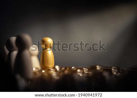 Success in Business or Talent Concept. Stand Out from the Crowd. Different and Individual Unique Person. Spotlight Shining to the Golden. presenting by wooden peg dolls Royalty-Free Stock Photo #1940941972