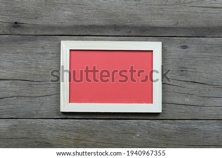 Empty vintage photo frame placed on old wood background and have copy space for your design in work.