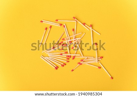 Red matches on the yellow background.
