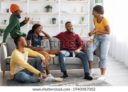 Group Of Black Friends Enjoying Drinks Party At Home Royalty-Free Stock Photo #1940987002