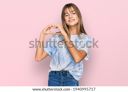 Teenager caucasian girl wearing casual clothes smiling in love showing heart symbol and shape with hands. romantic concept. 