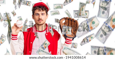 Young handsome man with curly hair wearing baseball uniform holding golve and ball thinking attitude and sober expression looking self confident