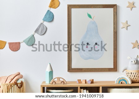 Stylish scandinavian newborn baby room with brown wooden mock up poster frame, toys, plush animal and child accessories. Cozy decoration and hanging cotton flags on the white wall. Template.