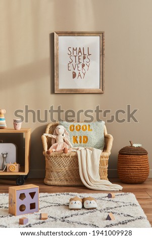 Stylish scandinavian kid room interior with toys, teddy bear, plush animal toys, rattan sofa, furniture, decoration and child accessories. Brown wooden mock up poster frames on the wall. Template