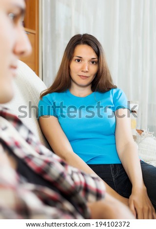 Couple conflict. Portrait of unhappy woman after quarrel in living room at home 