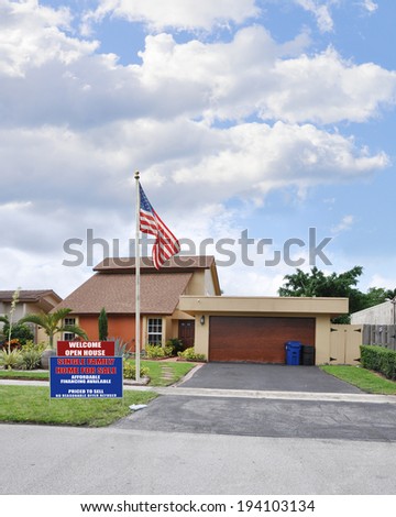 American Flag For Sale Real Estate Sign Open House Welcome Suburban home Residential Neighborhood USA Blue sky clouds