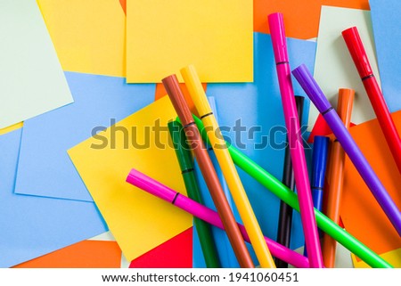 Sketch markers on the colorful paper background, paper board and empty space for text, cardboard