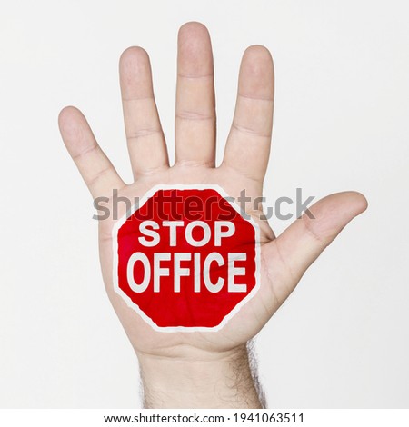 On the palm of the hand there is a stop sign with the inscription - STOP OFFICE. Isolated on white background.