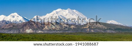 The landscape on the western portion of Denali National Park is extreme. From the point where this photograph was taken is about 30 miles from the Alaska Range. Even so Denali looks absolutely immense Royalty-Free Stock Photo #1941088687