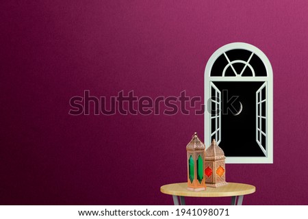 Ramadan concept. Ramadan Lanterns on a round table. wall background with a view of ramadan moon on the night sky. Space for text on the left. iftar concept image.

