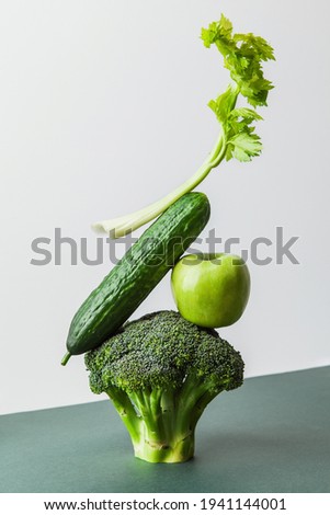 Fresh green vegetables on on the table. Equilibrium floating food  balance. Food creative concept, levitation