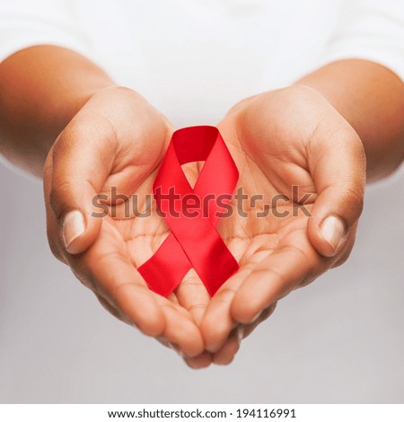 healthcare and medicine concept - female hands holding red AIDS awareness ribbon Royalty-Free Stock Photo #194116991