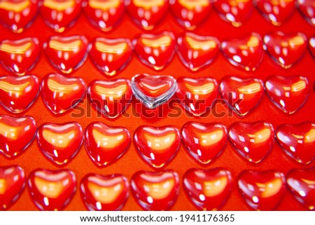 Hearts from glass for Valentine's Day on a red background.
