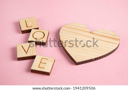 wooden heart and love on wooden cubes on table