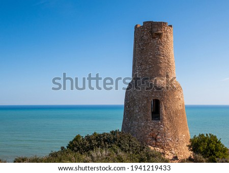 Different views of the beautiful Torre Del Gerro in Denia, with the Mediterranean Sea in the background on a clear and sunny day. Royalty-Free Stock Photo #1941219433
