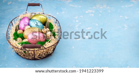 Happy Easter concept. Easter background for spring holiday. Festive composition with colorful Easter eggs on moss in basket. Copy space
