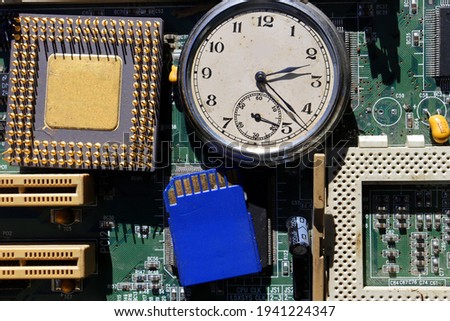 computer chip on circuit board and pocket watch