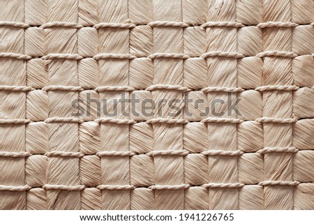 texture of a wicker mat, baskets, handbags made of natural materials, weaving of fibers, handmade with bark Royalty-Free Stock Photo #1941226765