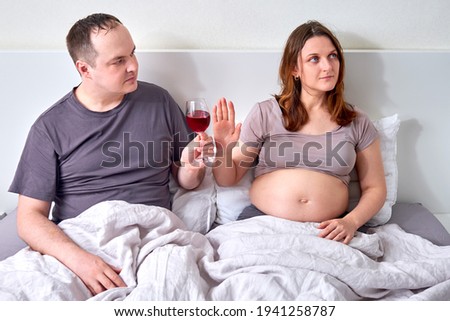 A pregnant woman refuses to drink alcohol. Hand gesture as a refusal of wine during pregnancy