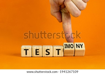 Test or testimony symbol. Businessman turns wooden cubes and changes the word 'test' to 'testimony'. Beautiful orange background. Business, test or testimony concept. Copy space.