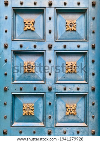 Fragment of entrance to St. Michael Cornhill church in the City of London, England. Vertical. Blue decorated with gold wooden door. Date of photo is 20.03.2021