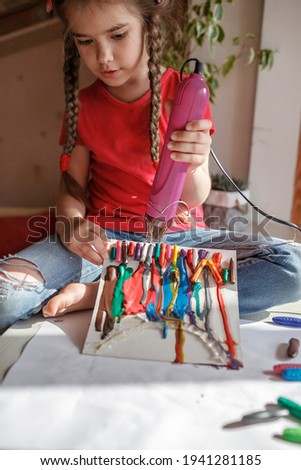 School girl drawing rainbow with melted crayon pencils, she using blow dryer and wax stars to melt, abstract art for kids with, original idea for social media campaign for coronavirus prevention