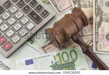 Judge gavel, calculator and euro and dollar banknotes