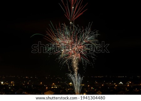 Fireworks light up the dark  sky like a flower , while New Year , festival celebrations