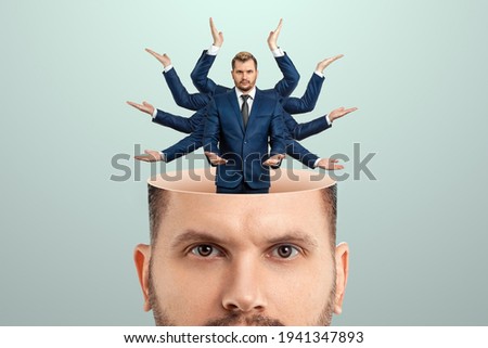 Instead of a brain, a man has a multi-armed businessman in his head. Creative picture, concept of multitasking, multi-hands, brain work, stress resistance