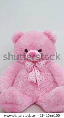 Pink teddy bear on the floor